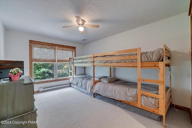 bedroom featuring ceiling fan, a textured ceiling, a baseboard heating unit, baseboards, and carpet