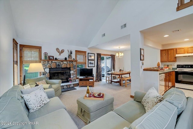 living area with light carpet, a stone fireplace, visible vents, and an inviting chandelier