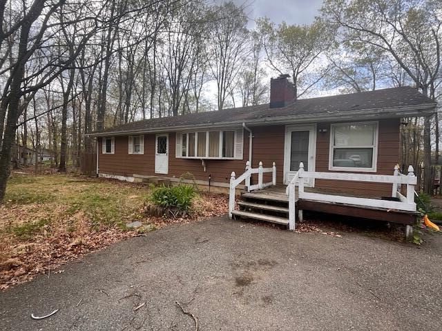 2121 Sassafras Ln, Kunkletown, PA 18058 - ranch-style home featuring a wooden deck and a chimney