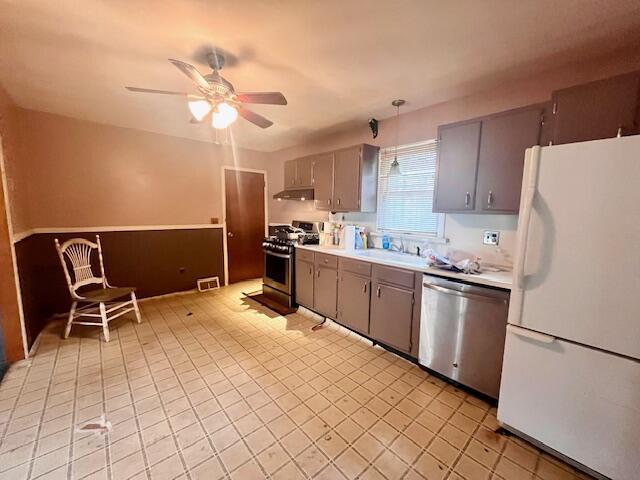 2121 Sassafras Ln, Kunkletown, PA 18058 - kitchen with under cabinet range hood, a ceiling fan, appliances with stainless steel finishes, and gray cabinets