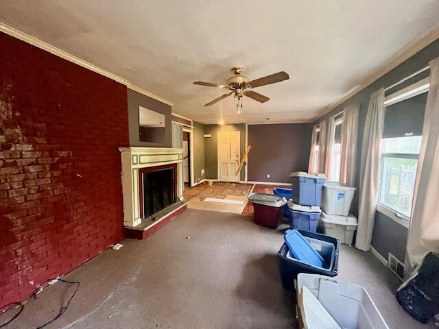 2121 Sassafras Ln, Kunkletown, PA 18058 - living area with ceiling fan, brick wall, visible vents, baseboards, and a fireplace with raised hearth