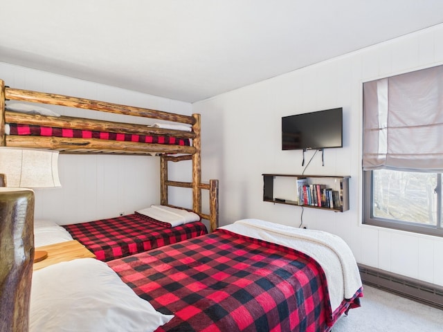 carpeted bedroom with a baseboard heating unit