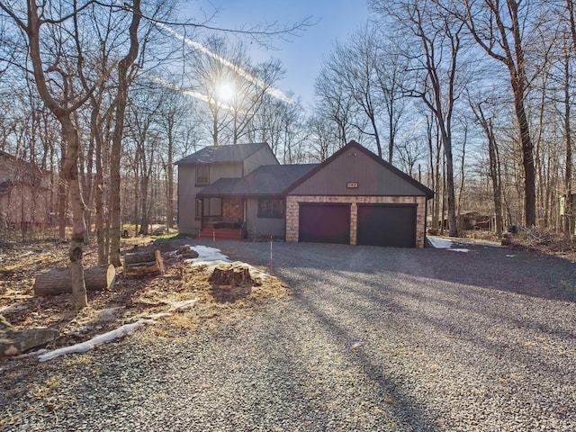 view of front of house featuring gravel driveway and an attached garage