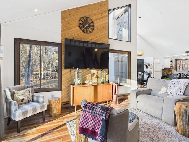 living room featuring high vaulted ceiling, wooden walls, and wood finished floors