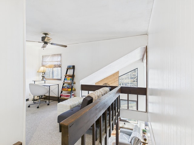 interior space with ceiling fan and carpet floors