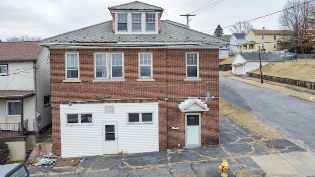 view of front of property featuring brick siding and fence