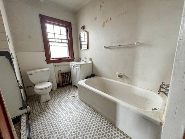 bathroom featuring toilet, vanity, a bath, and tile patterned floors