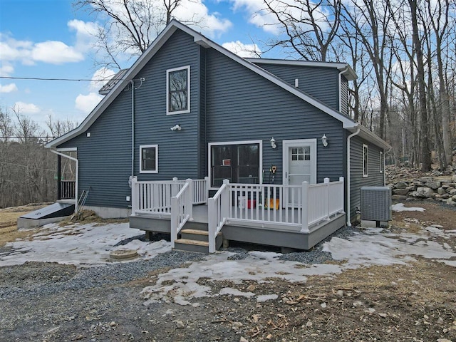 back of house with a deck and central air condition unit