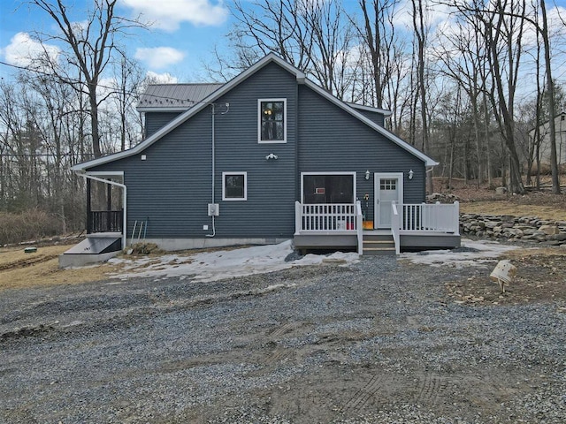 view of front of house with metal roof and a wooden deck