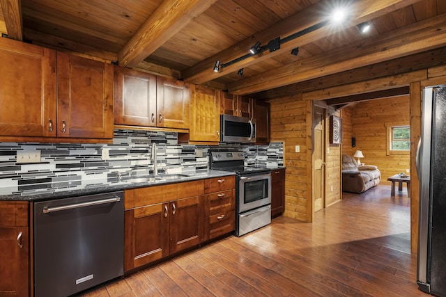 65 Poho Cir, Lehighton, PA 18235 - kitchen with appliances with stainless steel finishes, tasteful backsplash, a wood ceiling with exposed beams, wood-type flooring, and wood walls