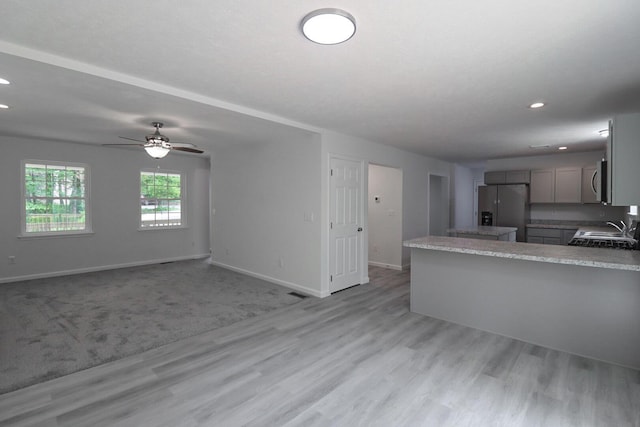 8305 Utopia Ln, East Stroudsburg, PA 18302 - kitchen featuring appliances with stainless steel finishes, gray cabinets, light wood finished floors, baseboards, and a ceiling fan