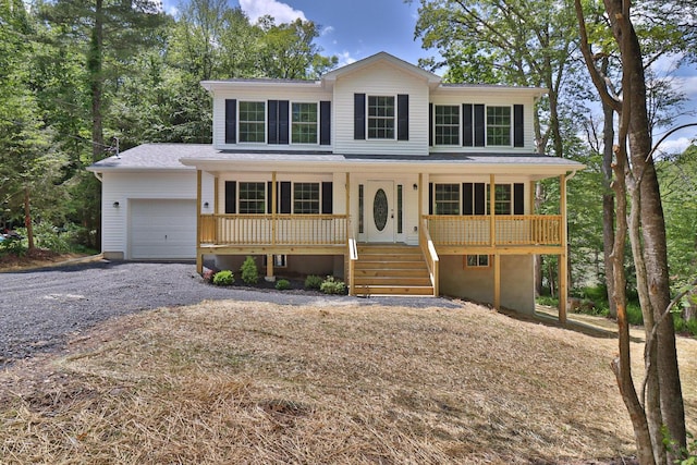 8305 Utopia Ln, East Stroudsburg, PA 18302 - view of front of home featuring a porch, a garage, gravel driveway, and roof with shingles