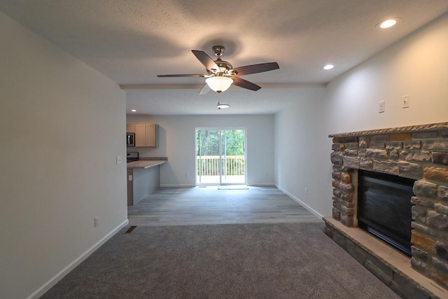 8305 Utopia Ln, East Stroudsburg, PA 18302 - unfurnished living room featuring carpet flooring, a fireplace, ceiling fan, baseboards, and recessed lighting