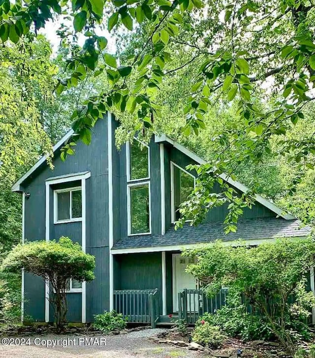 view of property exterior featuring roof with shingles