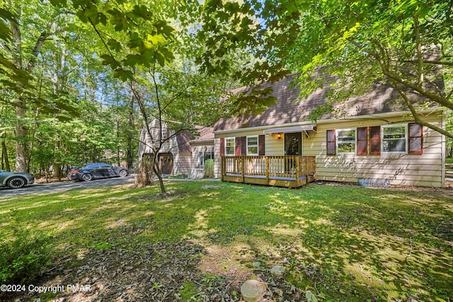 view of front of house featuring a front lawn and a wooden deck