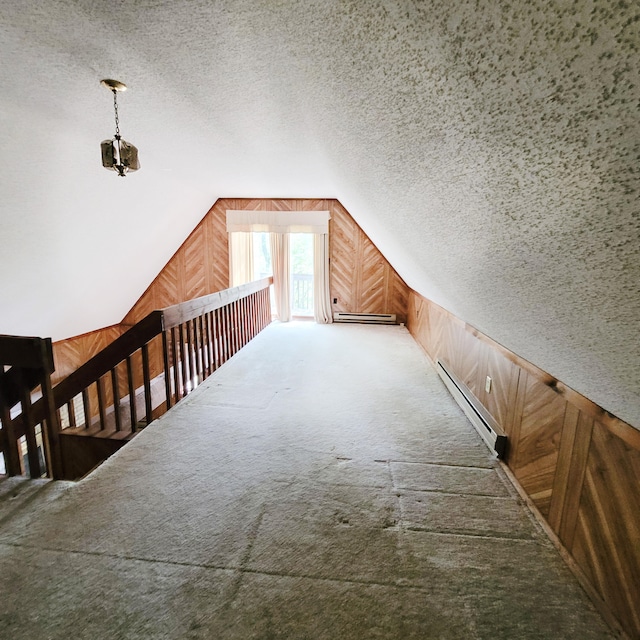 1119 Porter Dr, Bushkill, PA 18324 - additional living space featuring wood walls, a baseboard radiator, vaulted ceiling, carpet floors, and baseboard heating