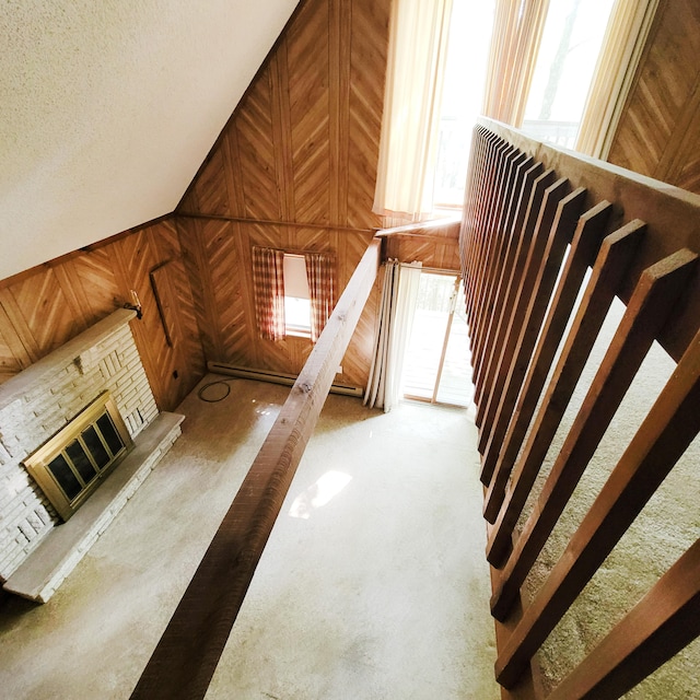 1119 Porter Dr, Bushkill, PA 18324 - staircase with wooden walls and a fireplace with raised hearth
