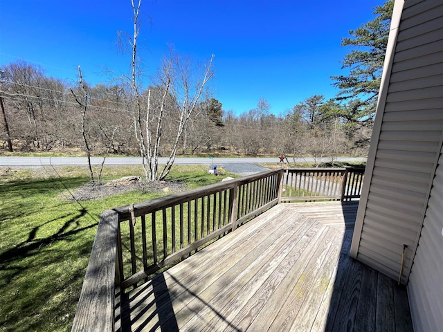 wooden deck featuring a yard
