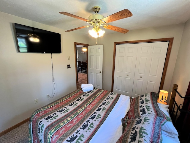 carpeted bedroom with a ceiling fan, baseboards, and a closet