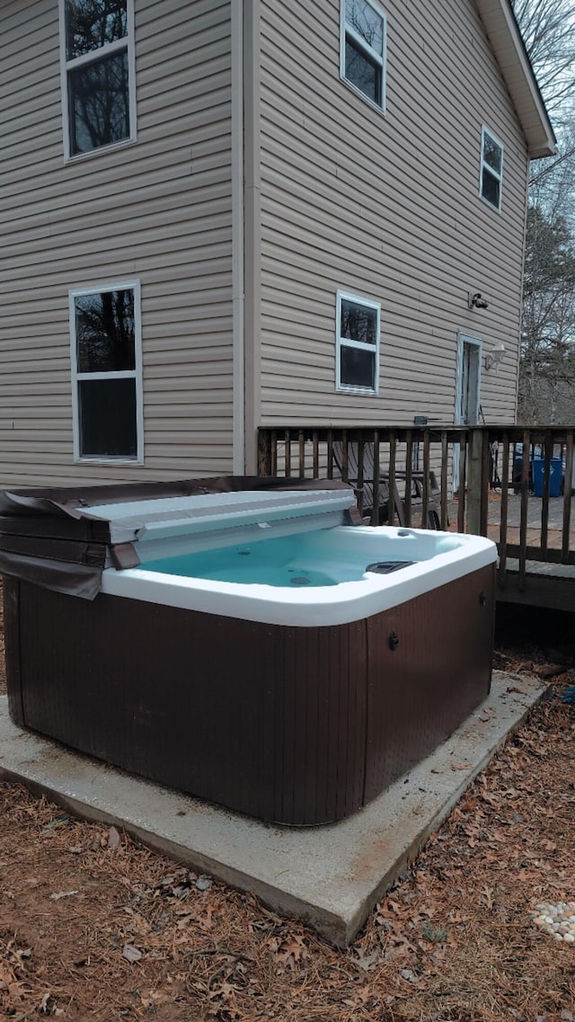 view of pool with a hot tub and a deck