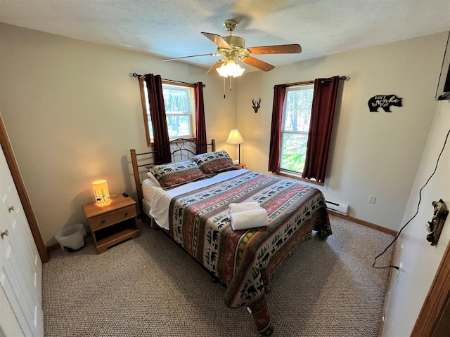 bedroom featuring baseboards, multiple windows, baseboard heating, and carpet flooring