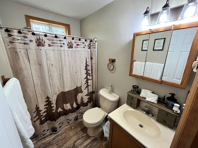 bathroom featuring toilet, a shower with curtain, wood finished floors, and vanity