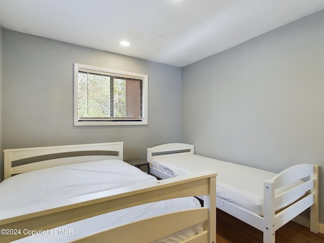 bedroom with wood finished floors and recessed lighting