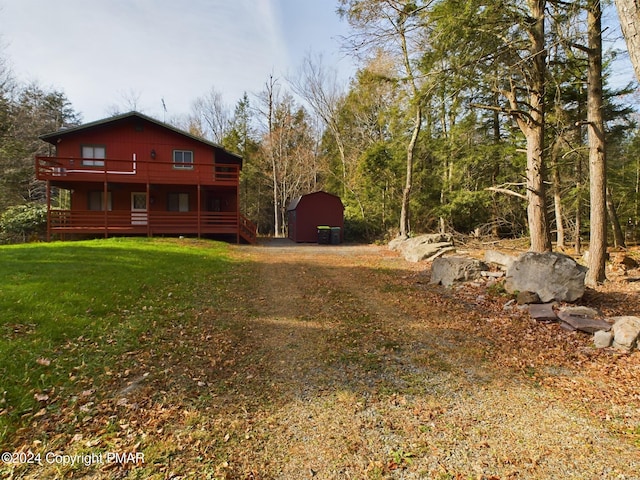 view of yard featuring a deck and an outbuilding