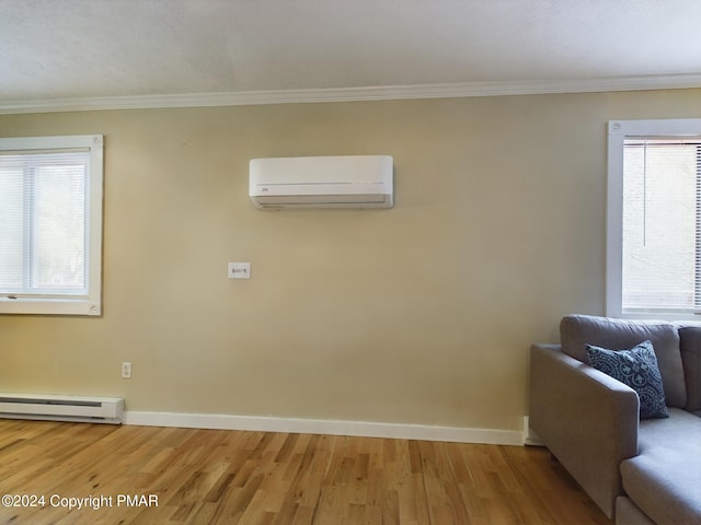 unfurnished living room featuring crown molding, baseboard heating, light wood-style floors, a wall mounted air conditioner, and baseboards