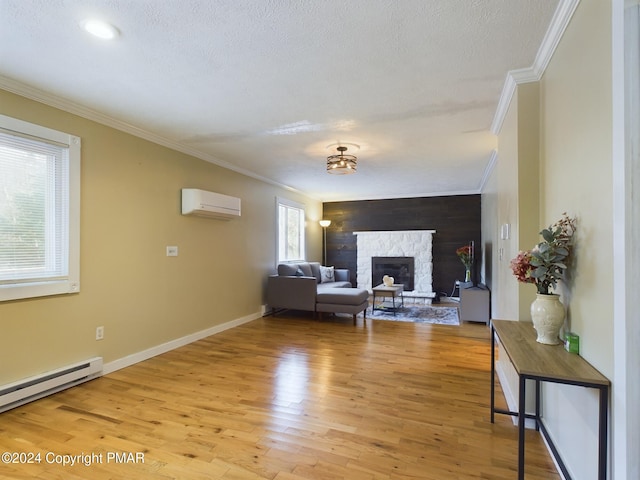 living room featuring a baseboard radiator, a fireplace, light wood-style floors, an AC wall unit, and crown molding