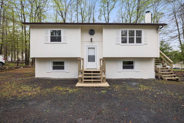 8066 Red Squirrel Dr, Tobyhanna, PA 18466 - view of front of home featuring a chimney, stairs, and entry steps