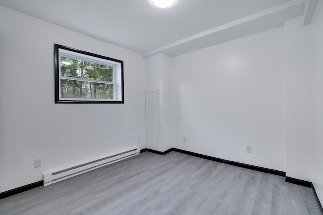8066 Red Squirrel Dr, Tobyhanna, PA 18466 - spare room featuring baseboards, a baseboard radiator, and wood finished floors