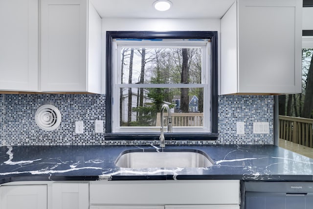 8066 Red Squirrel Dr, Tobyhanna, PA 18466 - kitchen featuring a sink, white cabinetry, and decorative backsplash