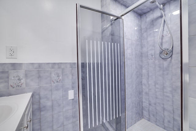 8066 Red Squirrel Dr, Tobyhanna, PA 18466 - bathroom with a shower stall, tile walls, and vanity
