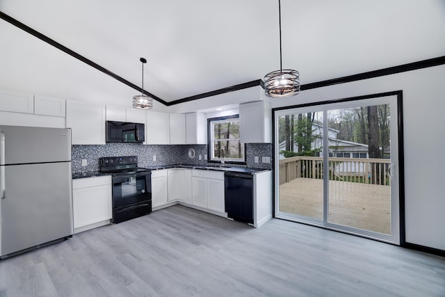 8066 Red Squirrel Dr, Tobyhanna, PA 18466 - kitchen with vaulted ceiling, a sink, dark countertops, black appliances, and decorative backsplash