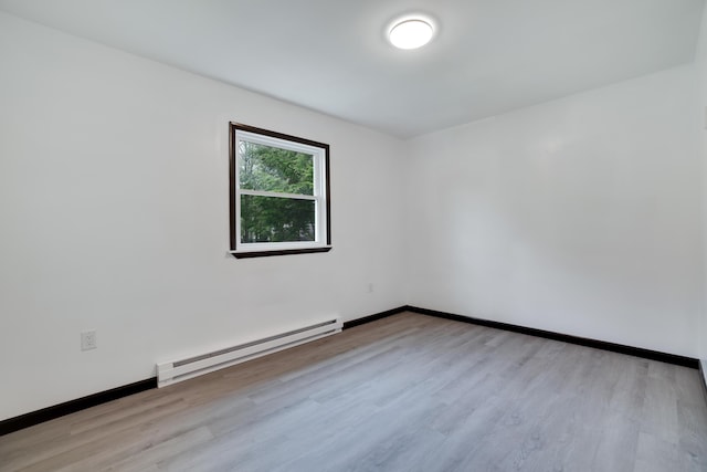 8066 Red Squirrel Dr, Tobyhanna, PA 18466 - spare room featuring wood finished floors, baseboards, and a baseboard heating unit