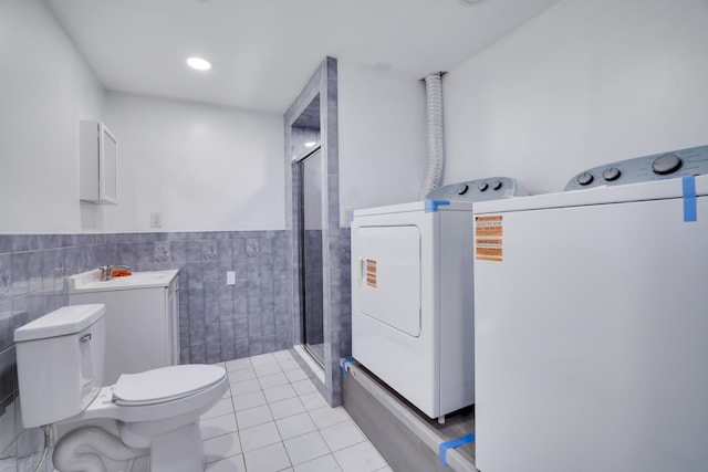 8066 Red Squirrel Dr, Tobyhanna, PA 18466 - bathroom with toilet, a stall shower, tile walls, tile patterned flooring, and wainscoting