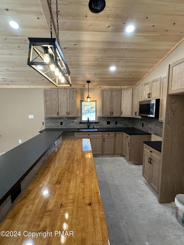 39 Wolf Way, White Haven, PA 18661 - kitchen with stainless steel microwave, lofted ceiling, a sink, backsplash, and wooden ceiling