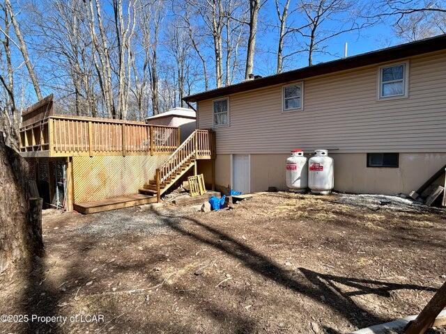 8 Tulip Ln, Thornhurst, PA 18424 - rear view of house with stairs and a wooden deck