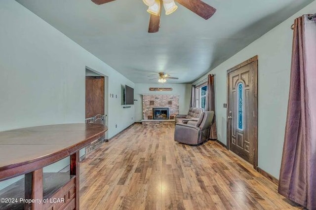 8 Tulip Ln, Thornhurst, PA 18424 - living room featuring a ceiling fan, light wood finished floors, and a brick fireplace