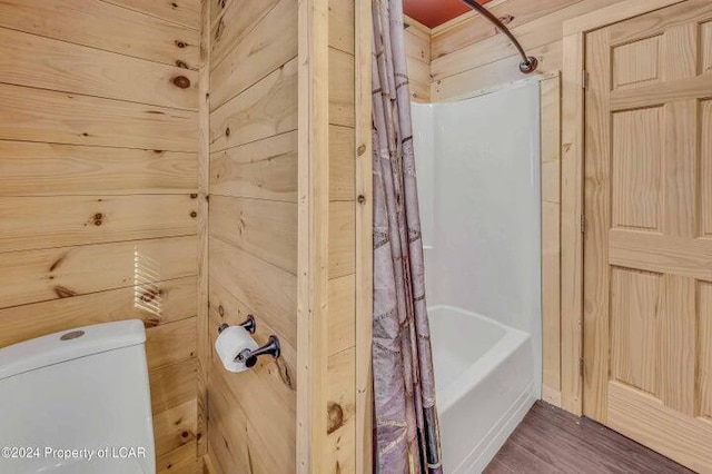 8 Tulip Ln, Thornhurst, PA 18424 - bathroom with shower / bath combo with shower curtain, wood finished floors, and wooden walls