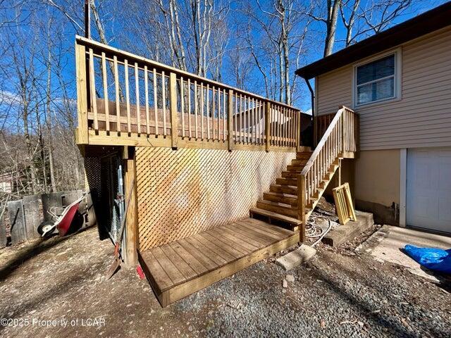 8 Tulip Ln, Thornhurst, PA 18424 - wooden deck featuring a garage and stairs