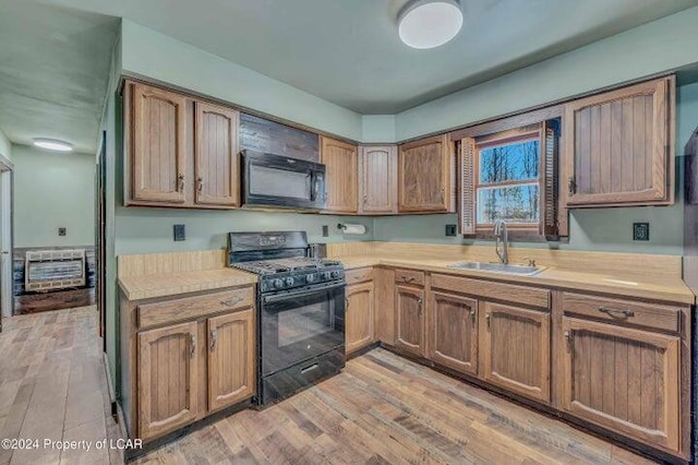 8 Tulip Ln, Thornhurst, PA 18424 - kitchen featuring black appliances, light countertops, light wood-style flooring, and brown cabinetry