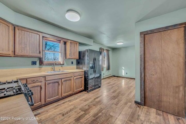 8 Tulip Ln, Thornhurst, PA 18424 - kitchen with black appliances, light countertops, light wood-style flooring, and brown cabinets