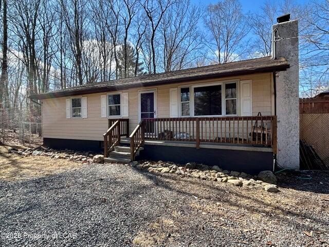 8 Tulip Ln, Thornhurst, PA 18424 - view of front of house with a porch and a chimney