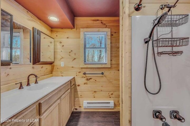 8 Tulip Ln, Thornhurst, PA 18424 - bathroom with a baseboard heating unit, vanity, wooden walls, wood finished floors, and  shower combination