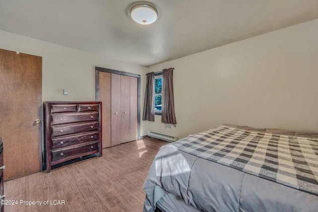 8 Tulip Ln, Thornhurst, PA 18424 - bedroom featuring baseboard heating, wood finished floors, and a closet