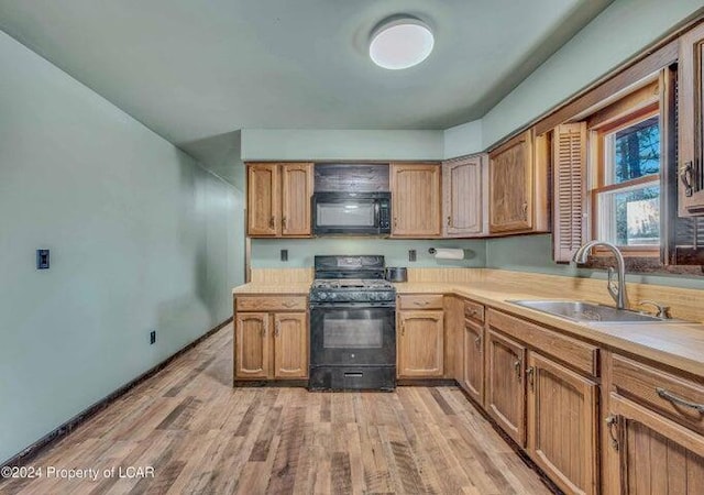 8 Tulip Ln, Thornhurst, PA 18424 - kitchen with gas range, black microwave, light countertops, and light wood-style flooring