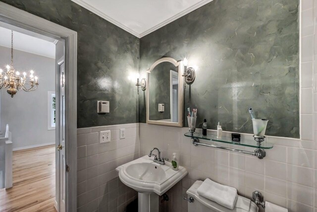 14 Ace Ln, East Stroudsburg, PA 18301 - bathroom with a chandelier, wood finished floors, tile walls, crown molding, and toilet