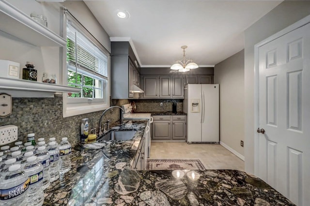 14 Ace Ln, East Stroudsburg, PA 18301 - kitchen with white fridge with ice dispenser, a sink, a chandelier, tasteful backsplash, and range